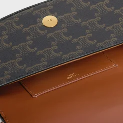 CLUTCH ON STRAP TABOU in Triomphe canvas and calfskin